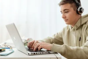 Student studying with headphones/CD player, calm and focused