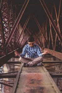Man Meditating in the Attic